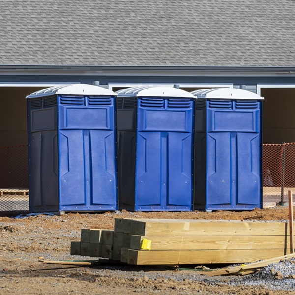 what is the cost difference between standard and deluxe portable restroom rentals in Herington